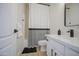 Well-lit bathroom features a shower with a striped shower curtain and a modern vanity with sleek black fixtures at 11629 W Washington St, Avondale, AZ 85323