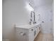 Bathroom features a white vanity with modern fixtures and framed mirror at 11629 W Washington St, Avondale, AZ 85323