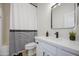 Bright bathroom with white vanity, modern fixtures, framed mirror, and a tub/shower with striped curtain at 11629 W Washington St, Avondale, AZ 85323