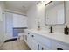 Bright bathroom featuring a white vanity with dark hardware, modern fixtures, framed mirror, and a tub/shower at 11629 W Washington St, Avondale, AZ 85323