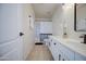 Bright and airy bathroom features a white vanity, modern fixtures, framed mirror, and shower with striped curtain at 11629 W Washington St, Avondale, AZ 85323
