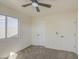 Bedroom with a fan, window, carpet and closet at 11629 W Washington St, Avondale, AZ 85323