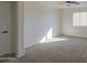 Bedroom featuring neutral carpet, ample natural light, and white painted trim at 11629 W Washington St, Avondale, AZ 85323