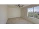 Bedroom featuring a ceiling fan, window with bright light and plush carpeting at 11629 W Washington St, Avondale, AZ 85323
