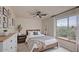 A comfortable bedroom featuring a queen bed, a neutral color palette, and a large window at 11629 W Washington St, Avondale, AZ 85323