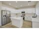 Modern kitchen with stainless steel appliances, white cabinets, quartz countertops and island at 11629 W Washington St, Avondale, AZ 85323
