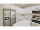 Spacious kitchen with stainless steel appliances, white cabinetry, quartz countertops and kitchen island at 11629 W Washington St, Avondale, AZ 85323