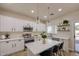 Modern kitchen with white cabinets, stainless steel appliances, and a center island with seating at 11629 W Washington St, Avondale, AZ 85323
