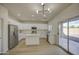 Modern kitchen featuring stainless steel appliances, white cabinets, quartz countertops and island open to dining at 11629 W Washington St, Avondale, AZ 85323