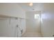Bright laundry room with tile floors, utility sink hookup, and a window at 11629 W Washington St, Avondale, AZ 85323