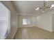 Bright living room featuring modern lighting, light hardwood floors, and natural light from large windows at 11629 W Washington St, Avondale, AZ 85323