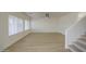 Bright living room with hardwood floors, ceiling fan, large windows, and a staircase leading upstairs at 11629 W Washington St, Avondale, AZ 85323