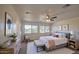 Serene main bedroom featuring a queen bed, large windows, and a neutral color palette at 11629 W Washington St, Avondale, AZ 85323