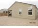 Home exterior with covered patio in a large, gravel backyard and block wall at 1246 E Thomas Dr, Casa Grande, AZ 85122