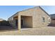 Rear exterior showcasing covered patio with sliding glass door access to the backyard at 1246 E Thomas Dr, Casa Grande, AZ 85122