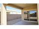 Covered patio with view of side yard and house next door through the sliding glass door at 1246 E Thomas Dr, Casa Grande, AZ 85122