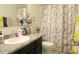Bathroom featuring a shower with a patterned curtain, a sink with cabinets, and a mirror at 1246 E Thomas Dr, Casa Grande, AZ 85122