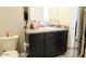 Bathroom featuring a sink with cabinets, a toilet, and an entrance at 1246 E Thomas Dr, Casa Grande, AZ 85122