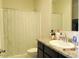 Bathroom featuring a shower with a curtain, a sink, and a toilet at 1246 E Thomas Dr, Casa Grande, AZ 85122