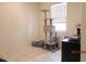 Neutral-toned bedroom featuring a cat tree, natural light, and tiled flooring at 1246 E Thomas Dr, Casa Grande, AZ 85122