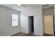 Neutral bedroom with a ceiling fan, window, and doorway, offering a serene and comfortable space at 1246 E Thomas Dr, Casa Grande, AZ 85122