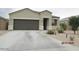 Charming single-story home with desert landscaping, walkway lights, and a two-car garage at 1246 E Thomas Dr, Casa Grande, AZ 85122
