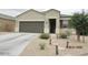 Charming single-story home with desert landscaping, walkway lights, and a two-car garage at 1246 E Thomas Dr, Casa Grande, AZ 85122