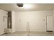 Clean, unfinished garage space featuring water heater and access door to house at 1246 E Thomas Dr, Casa Grande, AZ 85122