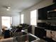 Bright kitchen with dark cabinets, stainless appliances, and an open layout to the living area at 1246 E Thomas Dr, Casa Grande, AZ 85122