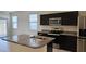 Modern kitchen features stainless steel appliances and dark cabinets at 1246 E Thomas Dr, Casa Grande, AZ 85122