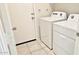 Bright laundry room with tile floors featuring a modern white washer and dryer set at 1246 E Thomas Dr, Casa Grande, AZ 85122