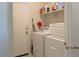 Laundry room equipped with a washing machine, a dryer, and storage shelves at 1246 E Thomas Dr, Casa Grande, AZ 85122