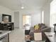 Living room with tile floors, a ceiling fan, sliding door to patio, and media center at 1246 E Thomas Dr, Casa Grande, AZ 85122