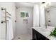 Updated bathroom with a shower, modern fixtures, updated lighting, and a vanity at 12529 N 83Rd Ln, Peoria, AZ 85381