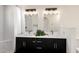 Beautiful bathroom featuring double sinks with modern fixtures, updated lighting, and modern tiling at 12529 N 83Rd Ln, Peoria, AZ 85381