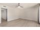 A neutral bedroom featuring vinyl floors, neutral walls, and a ceiling fan at 12529 N 83Rd Ln, Peoria, AZ 85381
