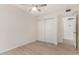 Cozy bedroom with vinyl floors, a ceiling fan, and a closet at 12529 N 83Rd Ln, Peoria, AZ 85381