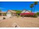 Charming home featuring a two-car garage, lush landscaping, and a stone walkway at 12529 N 83Rd Ln, Peoria, AZ 85381