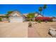 Charming home featuring a two-car garage, lush landscaping, and a stone walkway at 12529 N 83Rd Ln, Peoria, AZ 85381