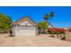 Charming home featuring a two-car garage, lush landscaping, and a stone walkway at 12529 N 83Rd Ln, Peoria, AZ 85381