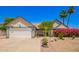 Charming home featuring a two-car garage, lush landscaping, and a stone walkway at 12529 N 83Rd Ln, Peoria, AZ 85381