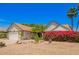 Charming home featuring a two-car garage, lush landscaping, and a stone walkway at 12529 N 83Rd Ln, Peoria, AZ 85381