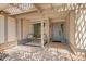 Inviting front porch with seating area, stylish rug, and decorative lattice at 12529 N 83Rd Ln, Peoria, AZ 85381