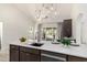 Bright kitchen boasts modern lighting, sleek countertops, stainless steel appliances, and access to the outdoor living area at 12529 N 83Rd Ln, Peoria, AZ 85381