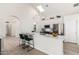 Stylish eat-in kitchen with white cabinets, stainless appliances, a skylight, and pendant lighting at 12529 N 83Rd Ln, Peoria, AZ 85381