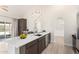 Open kitchen design with white quartz countertops and stainless steel appliances, and views of the backyard at 12529 N 83Rd Ln, Peoria, AZ 85381