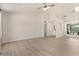 Spacious living room featuring lots of natural light and stylish, light-colored flooring at 12529 N 83Rd Ln, Peoria, AZ 85381