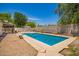 Backyard with pool, desert landscaping, a block fence and mature trees at 12529 N 83Rd Ln, Peoria, AZ 85381