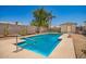 Backyard pool surrounded by mature trees, desert landscaping and a block fence at 12529 N 83Rd Ln, Peoria, AZ 85381