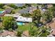 Aerial view of the home with lush backyard, swimming pool, mature shade trees, and a covered carport at 1298 E Buffalo St, Chandler, AZ 85225